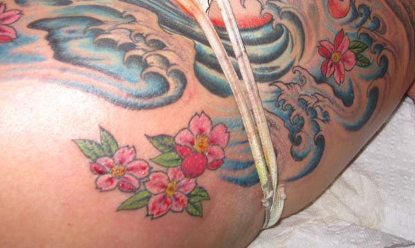 I added water waves and cherry blossoms to an existing tattoo